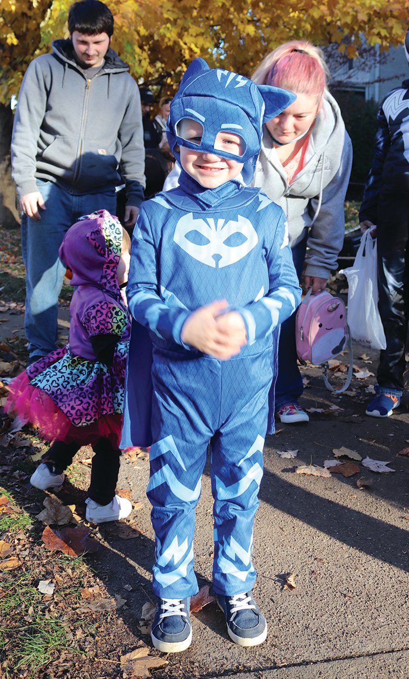 Catboy, also known as Lukas Hollis, 4, takes a break from his busy schedule to visit Main Street on Halloween night.